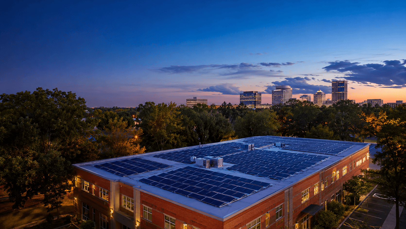 A commercial building with a large rooftop solar array at dusk